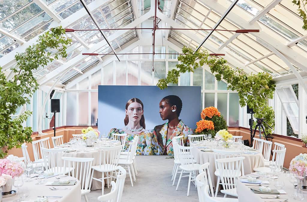Interior of green house set up for an event with tables and chairs. Georg Jensen launch. Credit: Chloe Paul