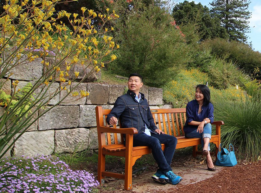 two people sitting on a bench smiling