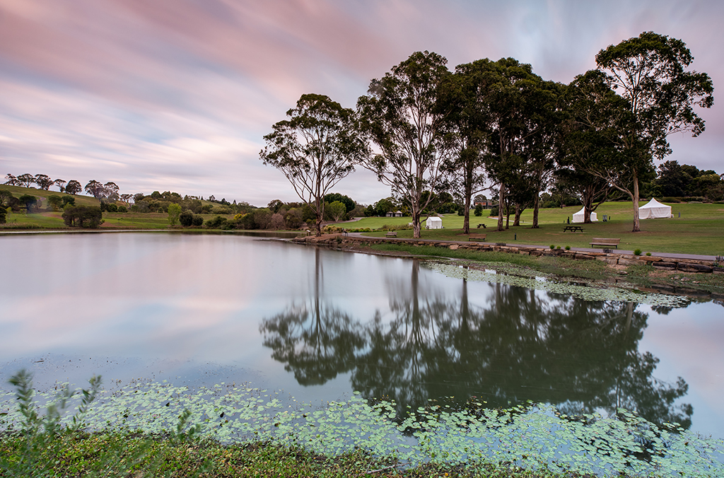 Lake with rolling green hills and bushland