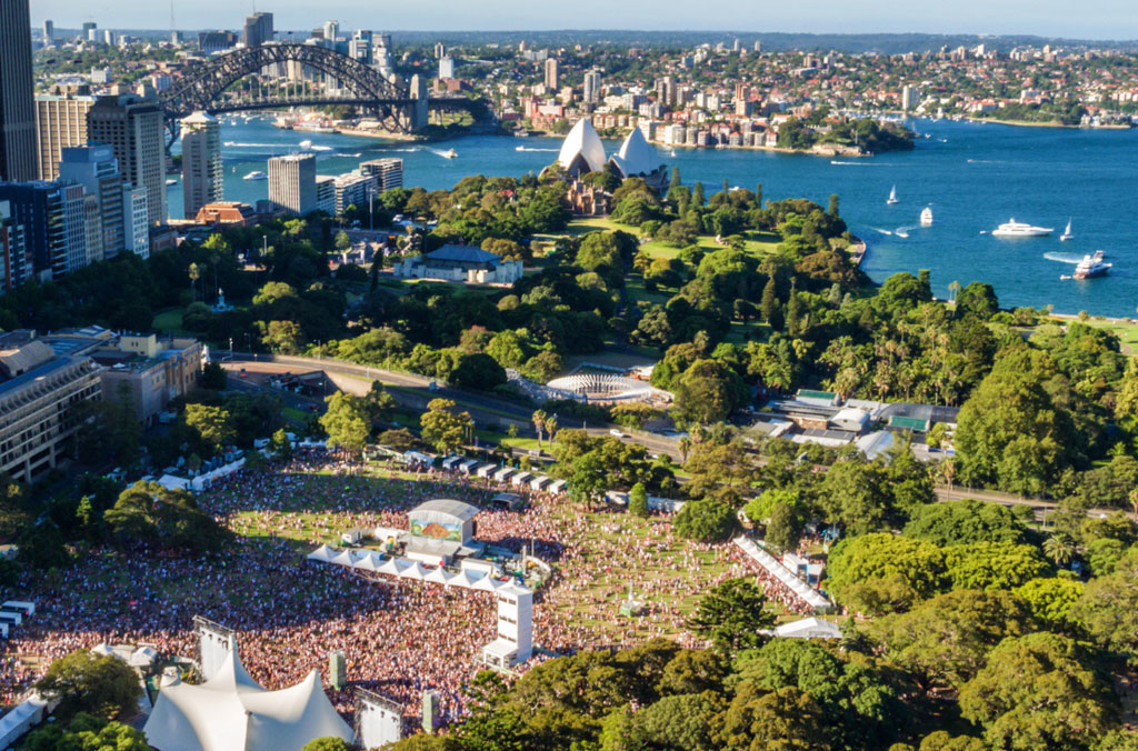 Aerial view of Field Day event at the Domain with the harbour and Sydney Harbour Bridge in the background