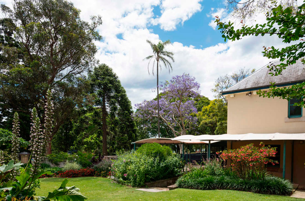 Garden setting with Lion Gate Lodge on the left