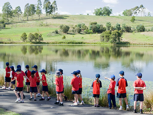 School children walking beside a lake at the Australian Botanic Garden Mount Annan