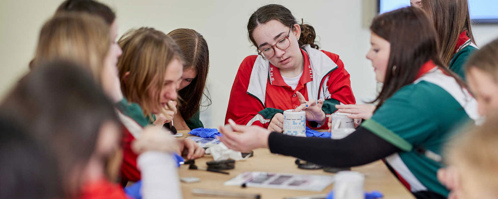 Secondary students working at a table together