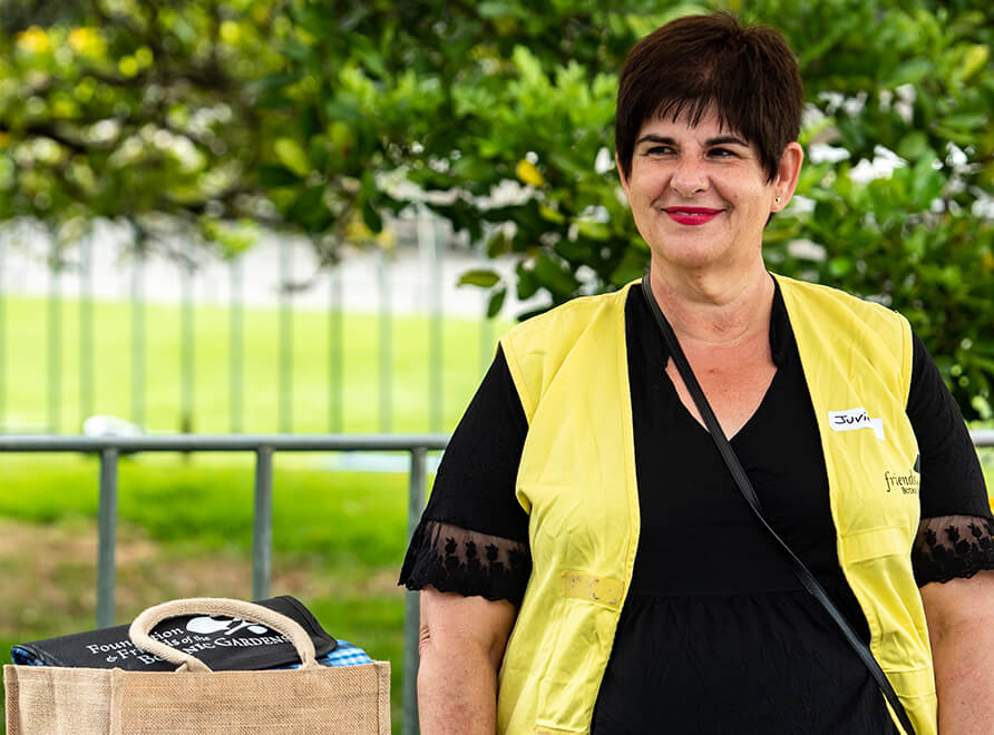 Volunteer with yellow vest in the garden