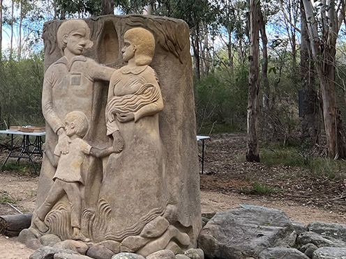 Stone sculpture of a mother, father and child