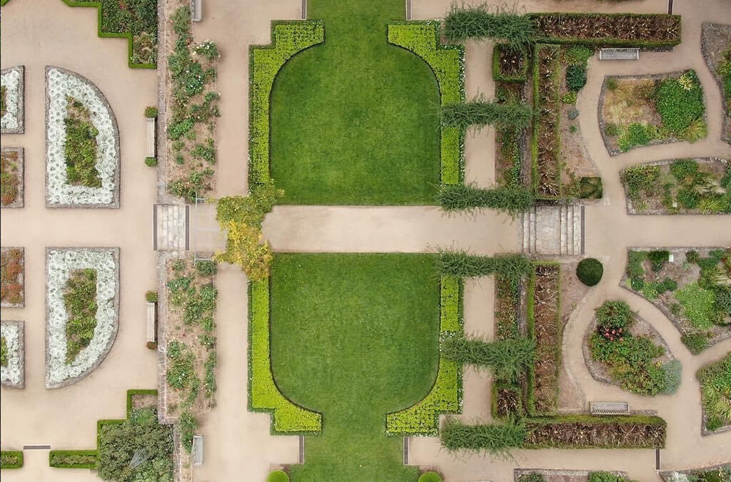 Aerial of a formal manicured garden with symmetrical winding paths