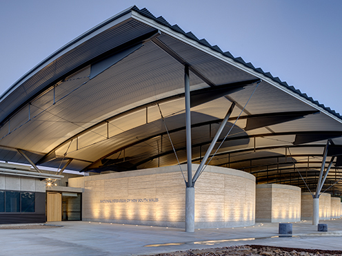 Elegant sandstone building with sweeping roof, the National Herbarium of New South Wales