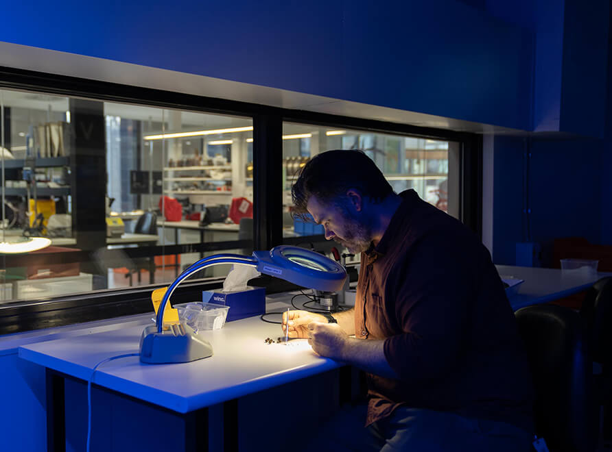 Scientist Nathan Emery examines seeds in a research lab