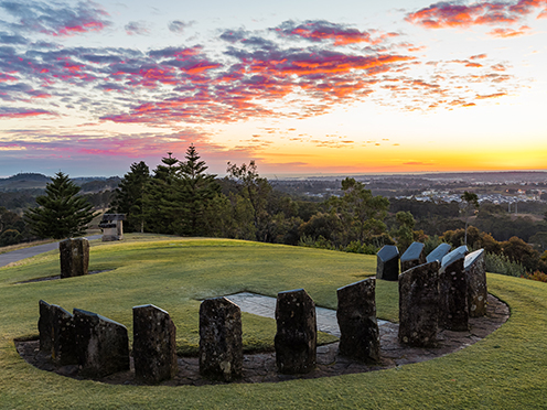 Sundial sculpture on top of hill at sunrise