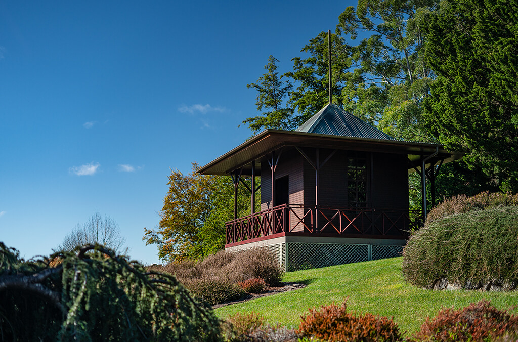 Chic pavilion among green lawns and lush gardens