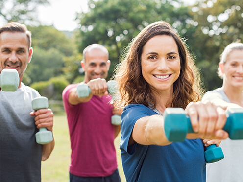 People with dumbbells in park