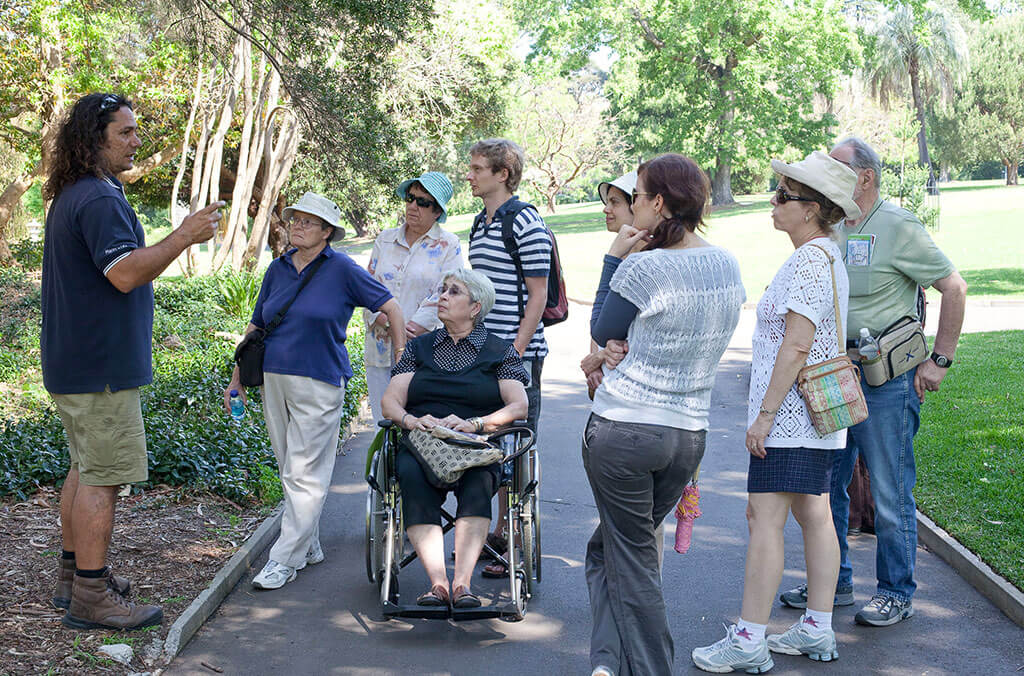 Group tour in the Royal Botanic Garden Sydney with one woman in a wheelchair 