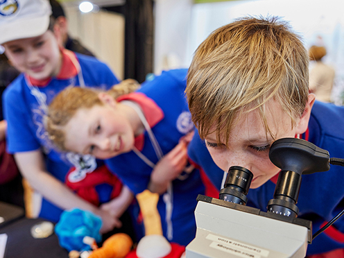 Boy looks through microscope