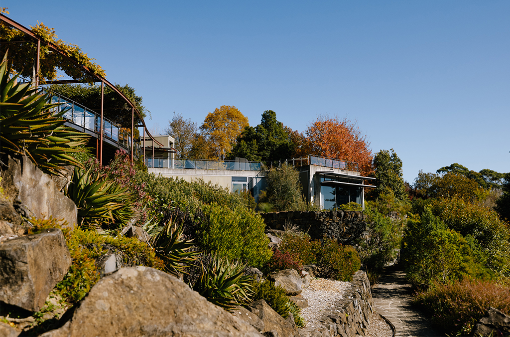 Visitor centre on a hill with garden paths below it