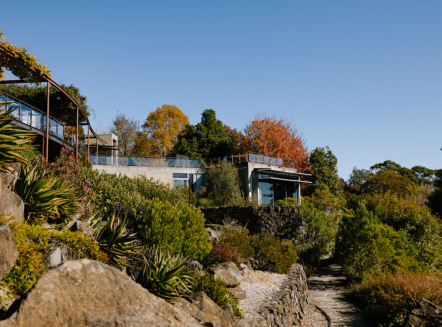 Visitor centre on a hill with garden paths below it