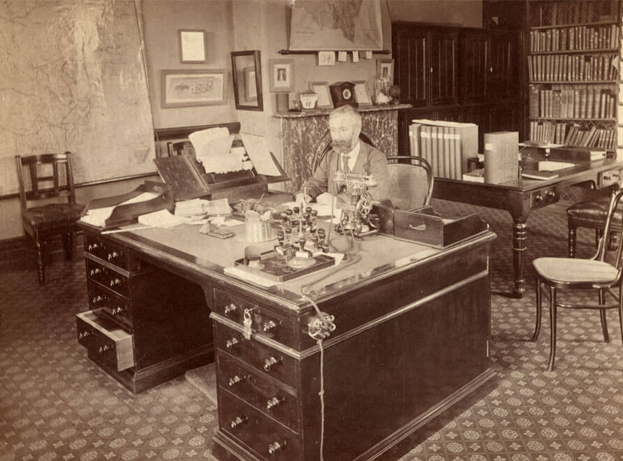 Joseph Maiden at a desk in the National Herbarium of New South Wales.
