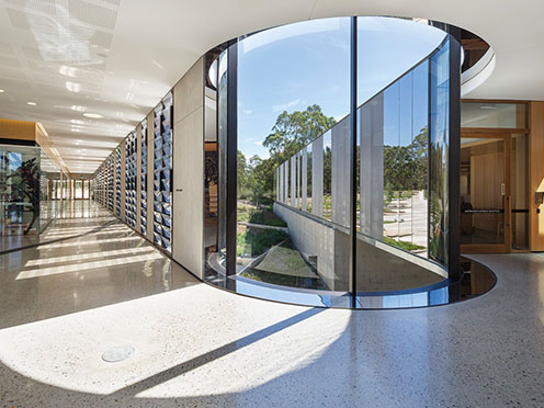 Curved window in the Telopea Gallery looking out towards the courtyard