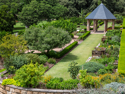 Aerial view of green, manicured garden with lawn and pavilion