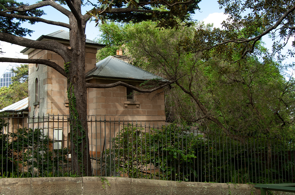 Sandstone cottage in shaded, leafy garden