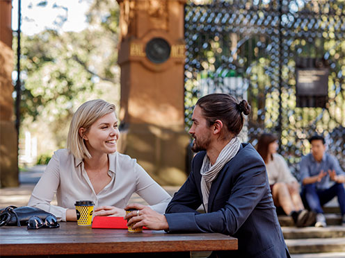 A couple sitting at Piccolo Me with takeaway coffees