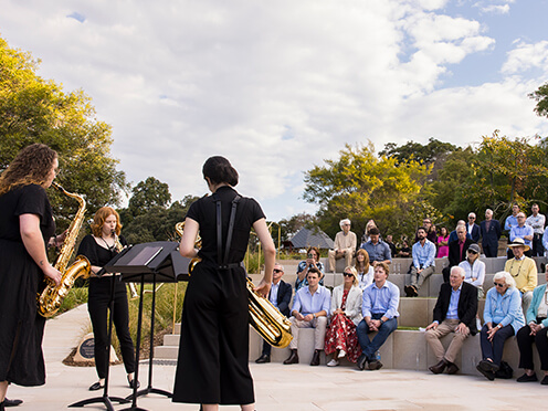 Saxophonists perform in amphitheatre in Garden