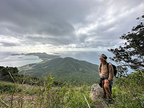 Brett Summerrell stands on a mountain range on Lord Howe Island