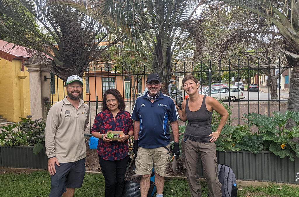 People attend the Forbes Street Community Garden