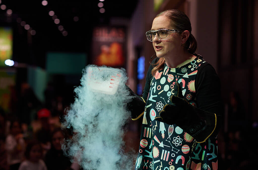 Woman doing a science experiment as part of the Creative Science Show