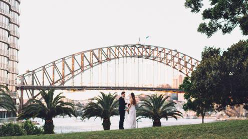 Bride and groom with panoramic Sydney Harbour views behind them