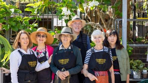 growing friends team of volunteers wearing matching aprons