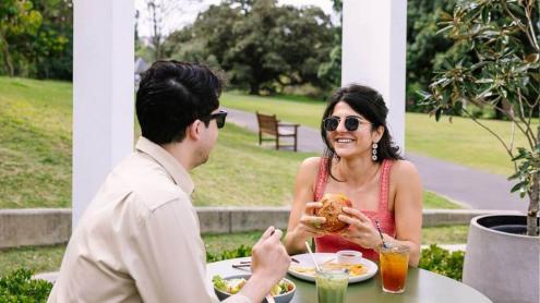 Two people enjoying a meal at an outdoor cafe patio