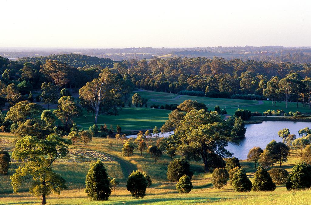 View of rolling hills, lake and distant mountains from top of sundial hill