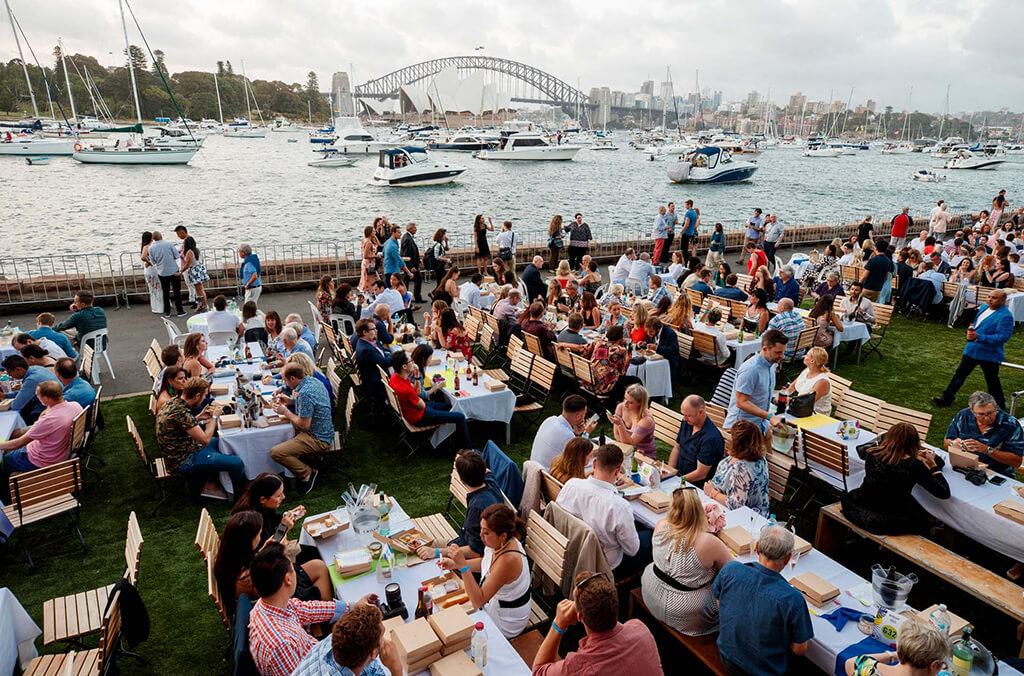 Dining tables filled with New Year's Eve diners overlooking Sydney Harbour