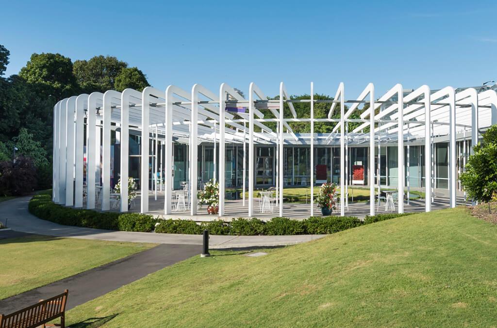 Architectural round building nestled in gardens