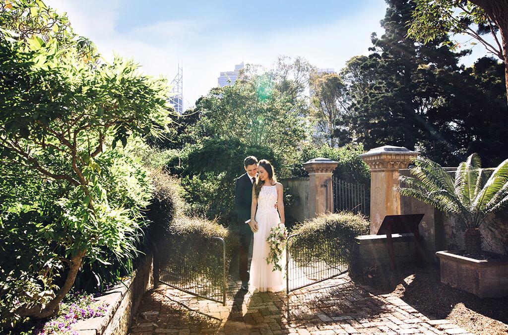 Bride and groom at rustic chic Lion Gate Lodge Garden gates