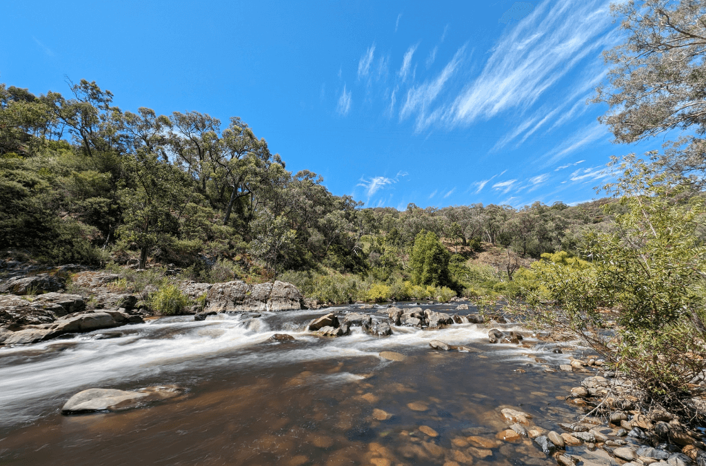 A river with rocks and a blue sky 