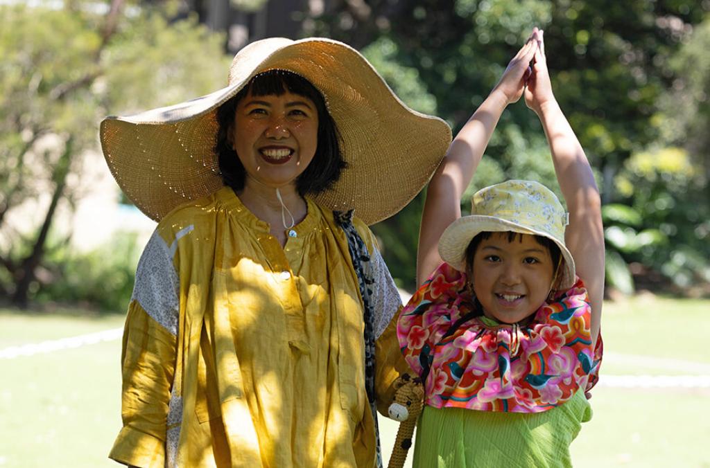 A women and child dressed up as a corpse flower