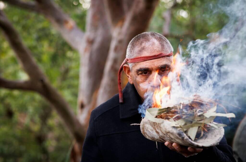 Uncle Dean Kelly led a smoking ceremony at the unveiling of the renewed Gadigal story journey at Cadi Jam Ora.