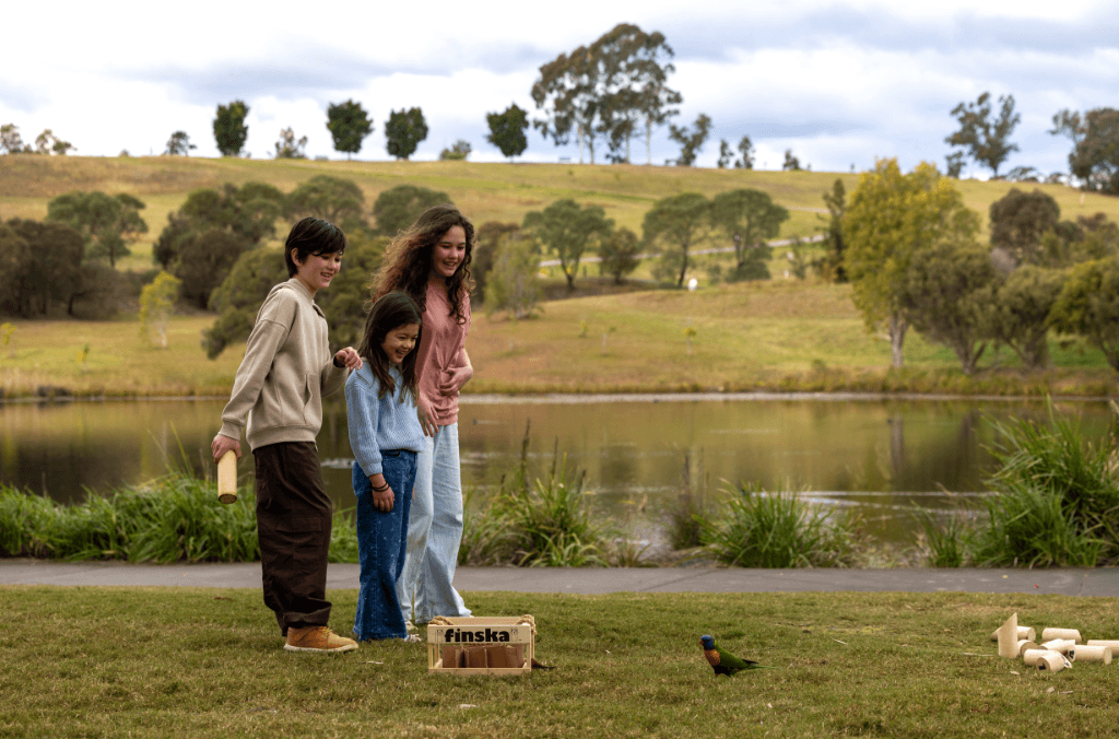 Kids near a lake playing a game in the garden