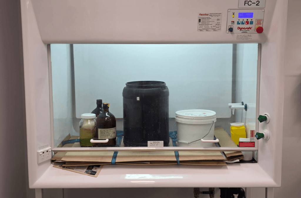 items pressing down on a plant press in a lab 